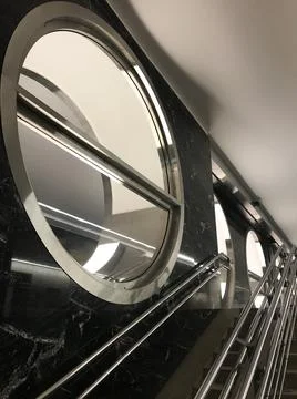 Marble surface with steel inserts in which light is reflected, round windows Stock Photos