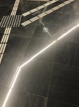 Marble surface with steel inserts in which light is reflected Stock Photos