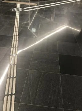 Marble surface with steel inserts in which light is reflected Stock Photos