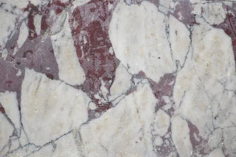 Marble surface with white and red patterns in natural light Stock Photos