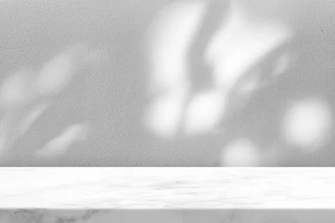 Marble Table with Leaves Shadow on Stucco Wall Texture Background Stock Photos
