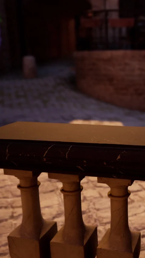 Marble table sits near stone pathway during evening time in quiet setting Stock Footage 339510569