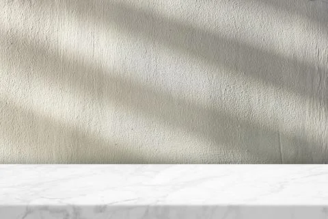 Marble Table with Stucco Wall Texture Background with Light Beam and Shadow Stock Photos