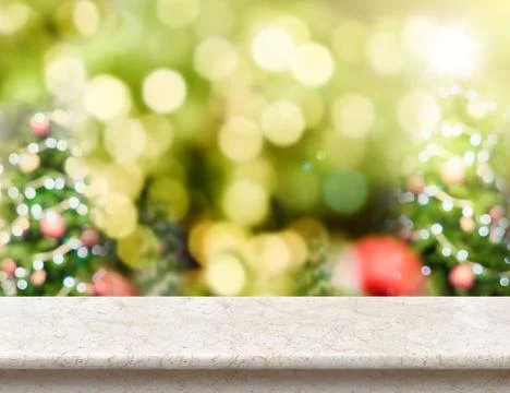 Marble table top with abstract blur christmas tree background with bokeh light Stock Photos