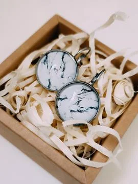 Marble texture stone earrings in small craft paper jewelry box, jewelry Stock Photos