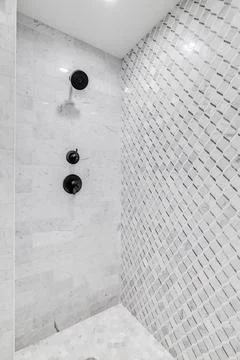 A marble tiled shower. Stock Photos