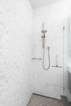 A marble tiled shower. Stock Photos