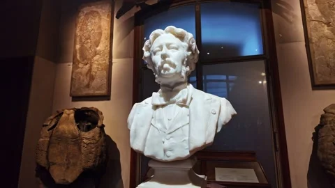 Marble white statue of Albert Gaudry in spotlight at National Museum of Natural Stock Footage 304566780