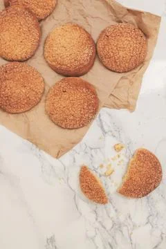 On a marble white table, sandy round cookies, one broken, top view, close-u.. Stock Photos
