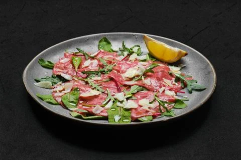 Marbled beef carpaccio on black background Foto stock