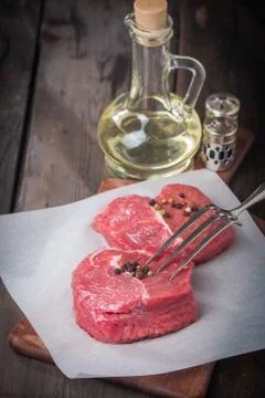 Marbled beef steak with a bottle of olive oil and salt Stock Photos