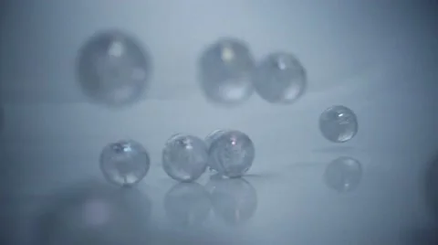 Marbles dropped in white background Stock Footage 60631329