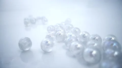 Marbles dropped in white background Stock Footage 60631346