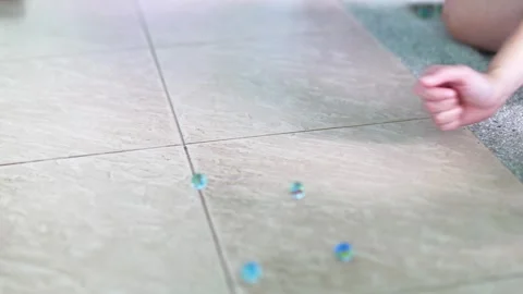 Marbles Rolling on Tiled Floor in Phuket Stock Footage 305018220