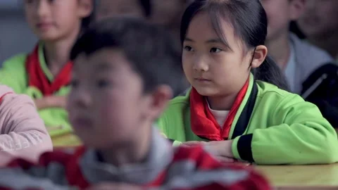 March 13, 2026: Elementary school students and teacher smiling in a classroom. Video stock 330637779