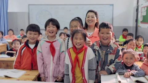 March 13, 2026: Elementary school students and teacher smiling in a classroom. Stock Footage 330637786