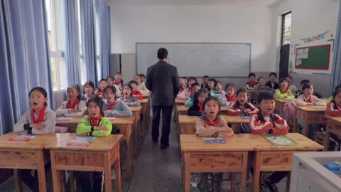 March 13, 2026: Elementary school students and teacher smiling in a classroom. Stock Footage 330637789