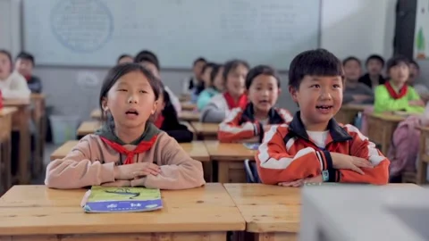 March 13, 2026: Elementary school students and teacher smiling in a classroom. Video stock 330637797