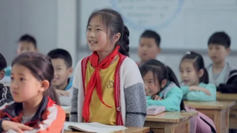 March 13, 2026: Elementary school students and teacher smiling in a classroom. Video stock 330637814