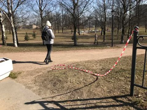 March 27, 2020 Russia Saint Petersburg - People walk through closed parks Stock Photos