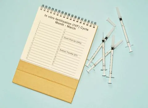 March IVF cycle calendar and disposable injection syringe Stock Photos