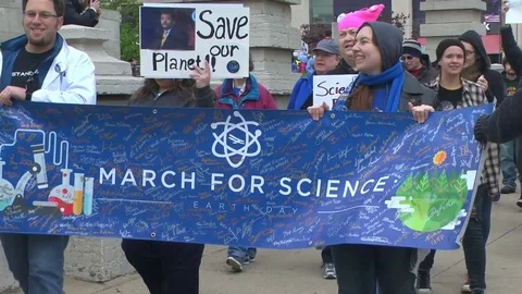 March for Science demonstrators carry signs and chant "Science not Silence" Stock Footage 74775505