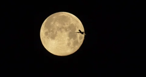 March Worm Moon 99.7% Full.  Waning Gibbous.  Jet fly by. Stock Footage 86622309