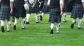 Marching bagpipe band with kilts lower boby at Highland Gathering HD Footage