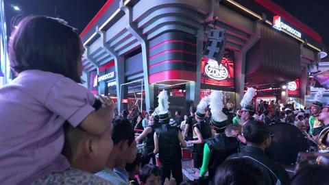 Marching band performing in front of a crowded booth during Jakarta Fair Video stock 338269439