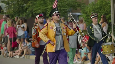 Marching band performs for spectators at a parade, in slow motion Stock-Footage 162786028