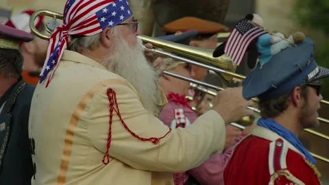 Marching band performs for spectators at a parade, in slow motion. 動画素材 162786299
