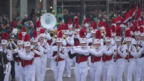 Marching band walking down in New York City at St. Patrick's day parade Video stock 236257813