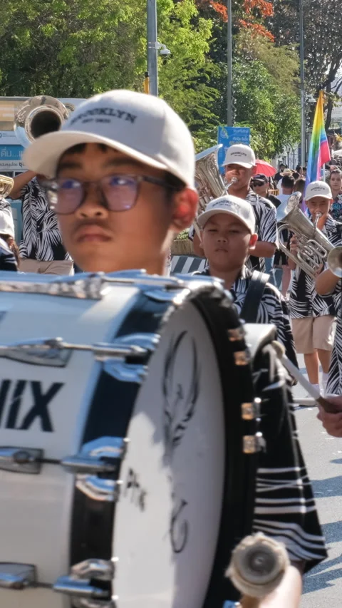 Marching musicians perform with drums and flags Stockbeeldmateriaal 347265111