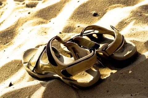Marching sandals on beach sand Stock Photos