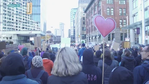 Marching the Streets in a Crowd of Protestors Stock Footage 139249723