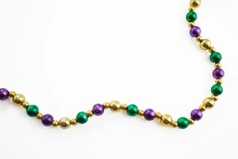 Mardi gras beads string forming a colorful diagonal border Foto stock