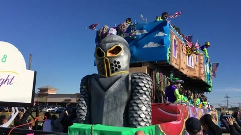 Mardi Gras Knight Float throwing beads to kids Stock Footage 66825213