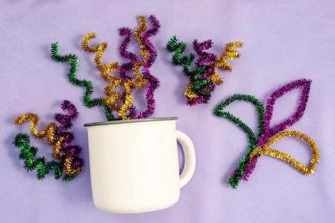 Mardi Gras Mockup. Empty blank white coffee mug on lilac background. Stock Photos