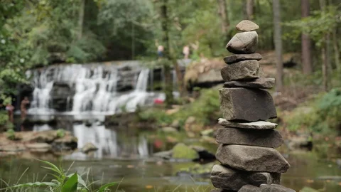 Mardis Mill Falls Stone Stack in Foreground Soft Focus People Swimming Video stock 96754260