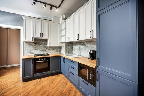 Marengo-colored kitchen in the apartment interior design Stock Photos
