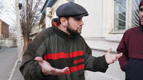 Marginalized men argue about roles in illegal structure Stock Footage 285407661