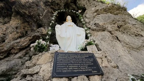 Maria statue on rock wall Stock Footage 70154257