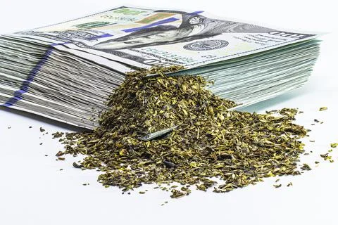 Marijuana on the background of a bundle of hundred dollar bills. Cannabis bus Photos