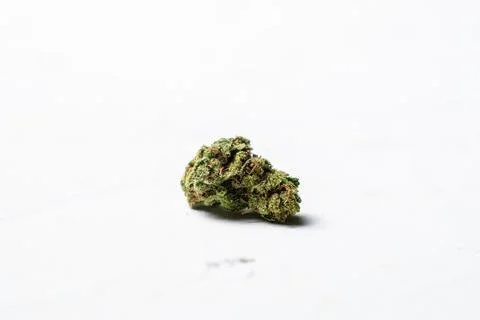 Marijuana bud on a white background. Microdosing concept. Stock Photos