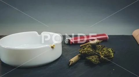 Marijuana buds and joint lie on a dark gray background. Marijuana is medicine Stock Photos