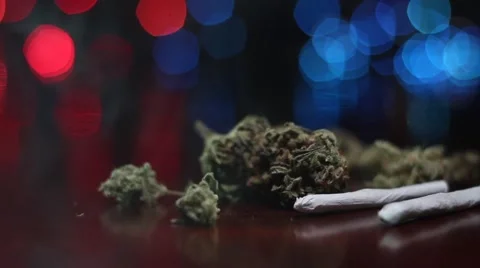 Marijuana with joints over a crime theme background Stock Footage 42790723