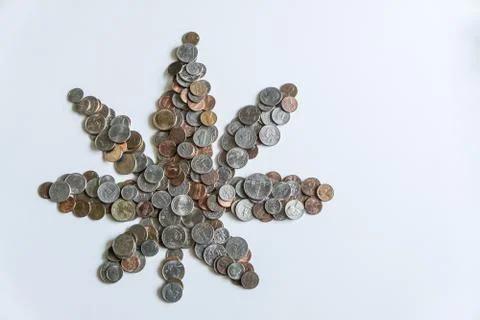 Marijuana leaf made of US American coins on solid white background Stock Photos