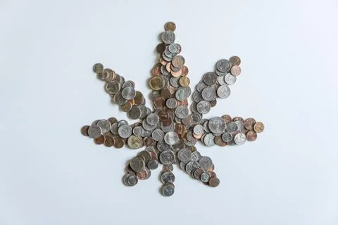 Marijuana leaf made of US American coins on solid white background Stock Photos