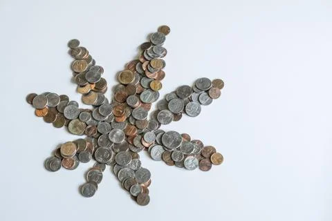 Marijuana leaf made of US American coins on solid white background Stock Photos