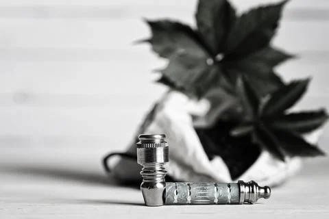 Marijuana pipe on wooden background Stock Photos